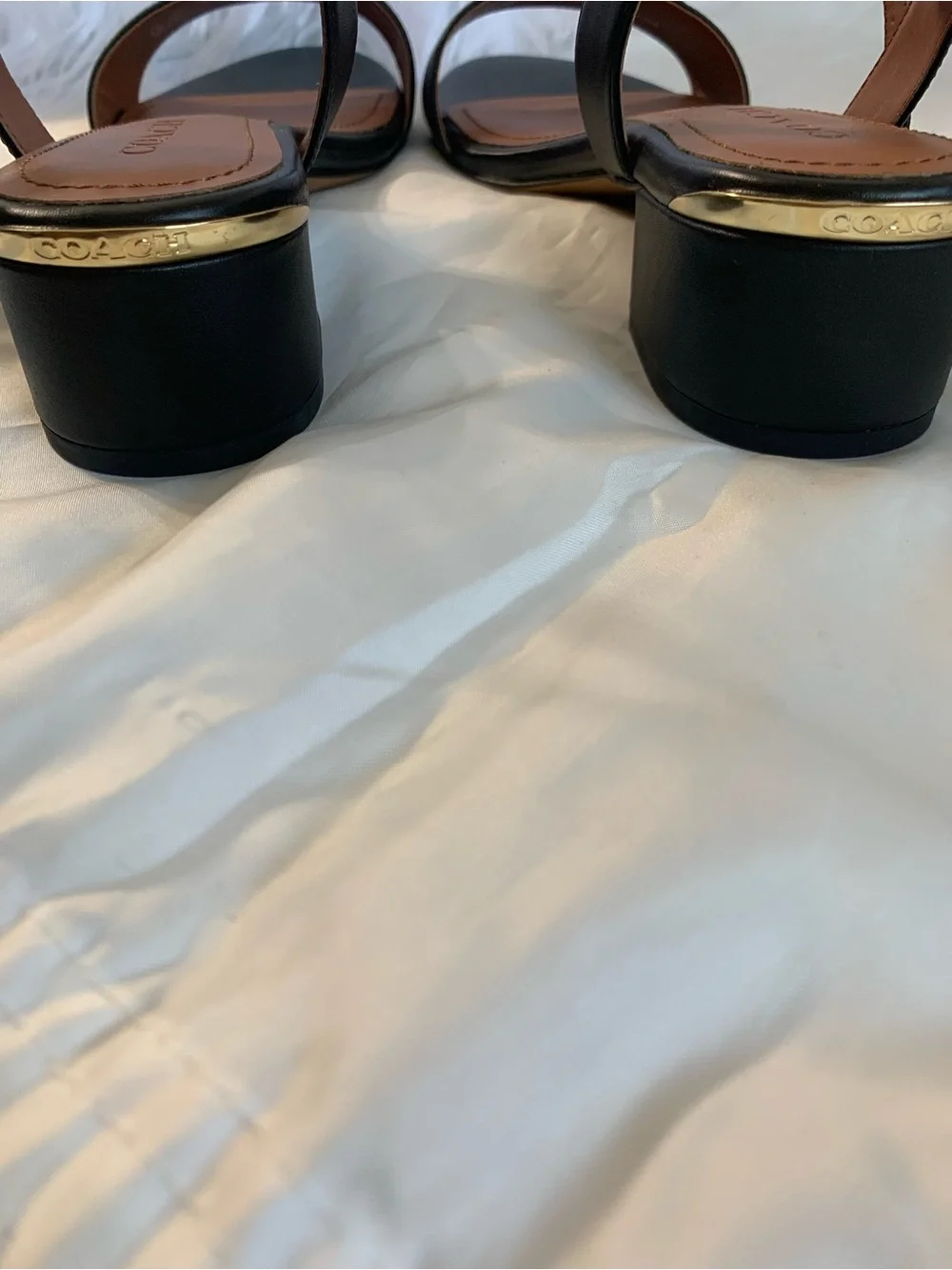 NWOT. Coach smooth leather, black sandals. Gold hardware.